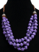 Collier ethniques artisanal imitation pierres mauves trois rangs agrémentées de perles en bois et de breloques argentées Collier ethniques artisanal imitation pierres mauves trois rangs agrementees de perles en bois et de breloques argentees