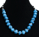 Collier ethnique artisanal imitation pierres bleues agrementees de perles en metal, noires et et blanches